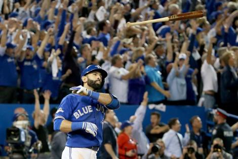 TORONTO, ON - OCTOBER 14: Jose Bautista #19 of the Toronto Blue Jays throws his bat up in the air after he hits a three-run home run in the seventh inning against the Texas Rangers in game five of the American League Division Series at Rogers Centre on October 14, 2015 in Toronto, Canada. (Photo by Tom Szczerbowski/Getty Images)